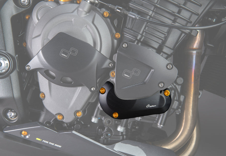 LighTech ECPTR007NER lower right pick-up cover protector - black. Installed view highlights the lower cover protector. The clutch cover protector, upper cover protector, coloured bolts and motorcycle are separate.