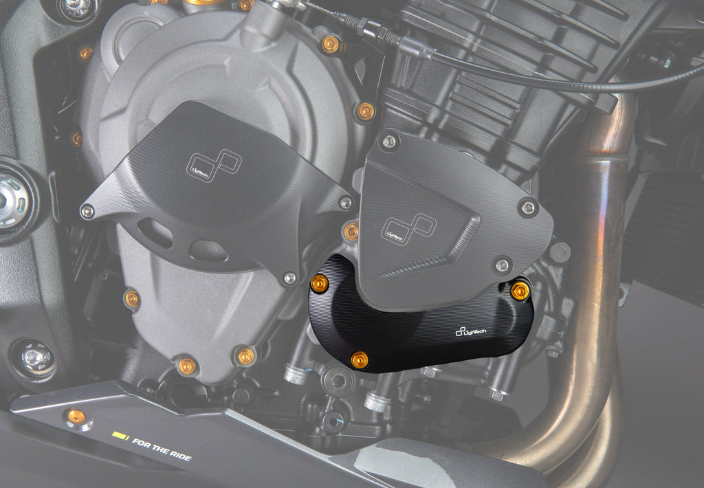 LighTech ECPTR007NER lower right pick-up cover protector - black. Installed view highlights the lower cover protector. The clutch cover protector, upper cover protector, coloured bolts and motorcycle are separate.