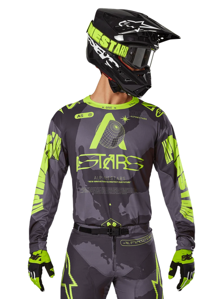 Alpinestars 2025 Racer Hollow Jersey, Motocross Racing Jersey, Dark Camo and Neon Yellow, worn with matching pants, black and yellow helmet with goggles, and black gloves, featuring Alpinestars branding and camouflage design