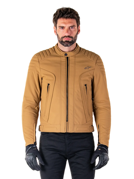 Alpinestars Clayton WR Jacket, Urban Motorcycle Jacket, Utility Brown Light Gold, water-resistant textile with quilted padded shoulders, high biker collar, black zipper details, and chest logo, worn with black protective gloves and pants