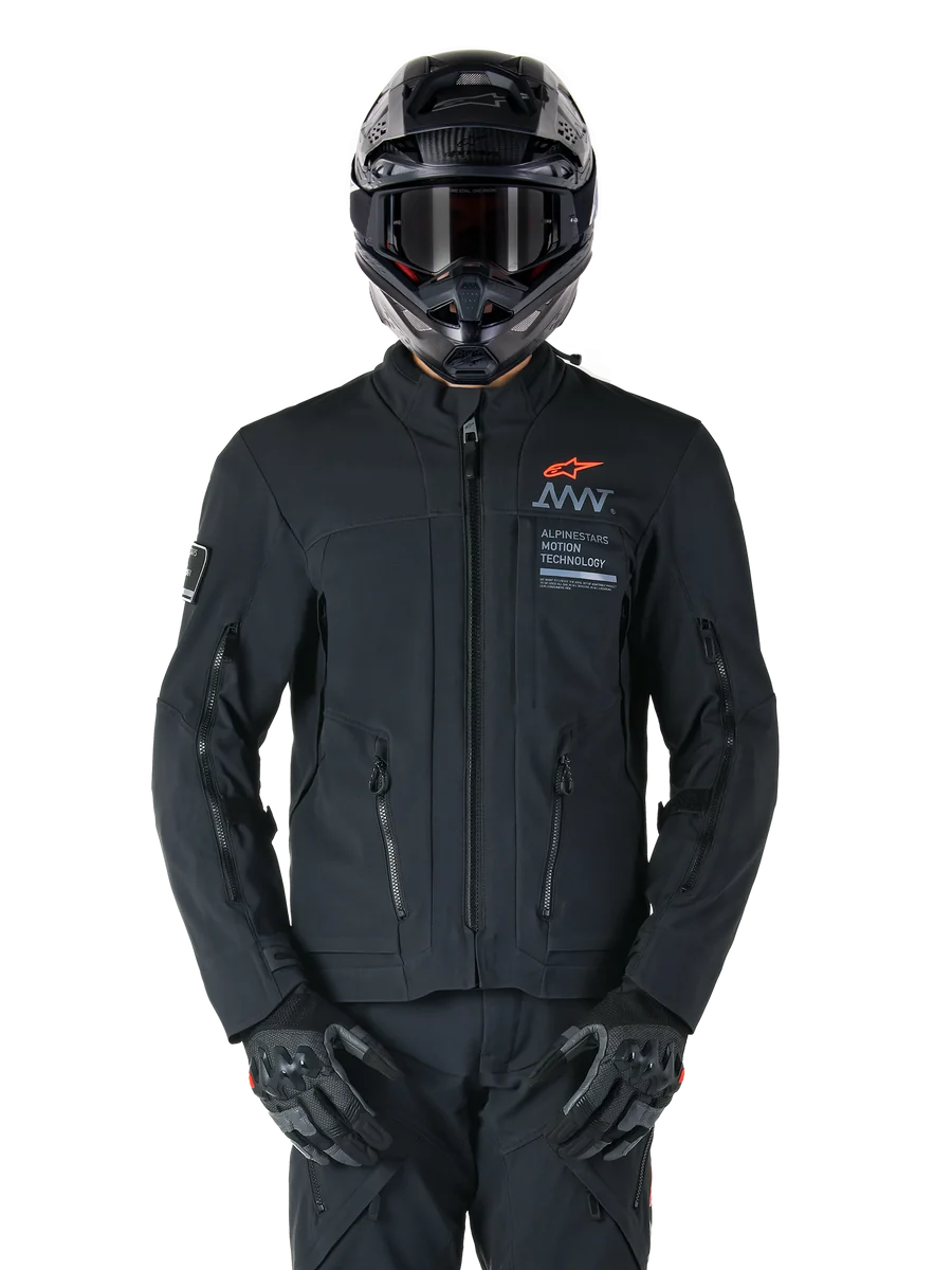 Alpinestars AMT-8 Stretch Drystar® XF Jacket, Black Motorcycle Jacket, featuring orange Alpinestars logo and grey AMT branding, high collar with front zipper and vents, worn with black helmet and gloves, protective adventure touring gear