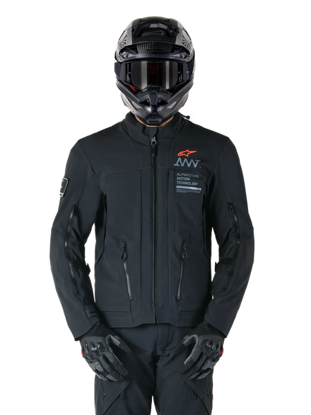 Alpinestars AMT-8 Stretch Drystar® XF Jacket, Black Motorcycle Jacket, featuring orange Alpinestars logo and grey AMT branding, high collar with front zipper and vents, worn with black helmet and gloves, protective adventure touring gear