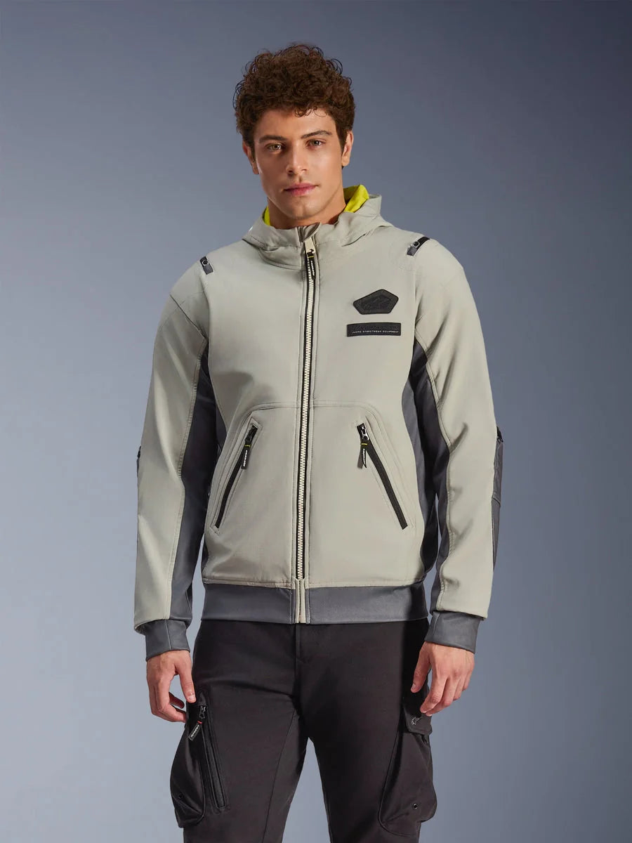 Alpinestars Moblast Waterproof Jacket, light gray and dark gray urban motorcycle hoodie with yellow hood lining, front pockets and black zippers, worn with black cargo pants, modern sporty design