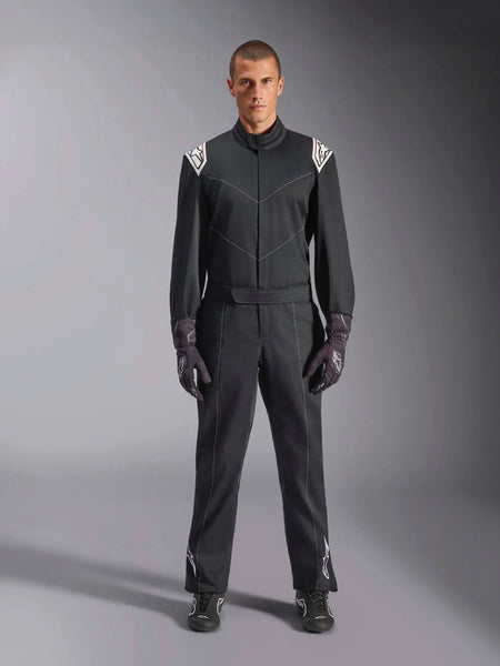 Alpinestars Kart Indoor V2 Suit, One-piece Karting Suit, Black, featuring white Astars logos on the shoulders and lower legs, adjustable waist belt and ergonomic collar, designed for recreational indoor karting