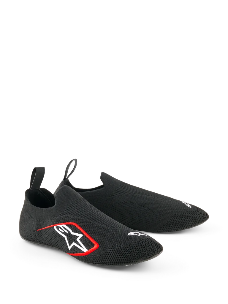 Alpinestars Tech Gaming Shoes, Sim-Racing Footwear, Black, featuring a seamless knitted stretch upper, white embroidered logo with red accents, low-profile sock-like design with rear pull tabs, optimized for pedal sensitivity