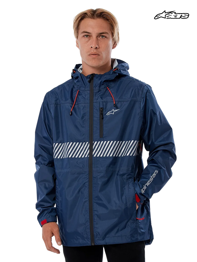 Alpinestars Fusion Rain Jacket, waterproof hard-shell rain jacket in navy, worn by a model, featuring a fixed hood with bungee adjusters, white chest graphic, and reflective details.