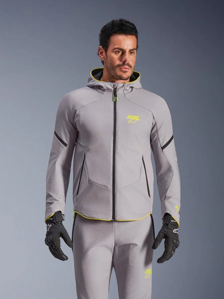 Alpinestars Aeroshell Waterproof Jacket, Mid Gray and Yellow Fluo, hooded motorcycle softshell jacket with black zippers, worn with matching gray pants and black gloves, waterproof performance gear for road riding