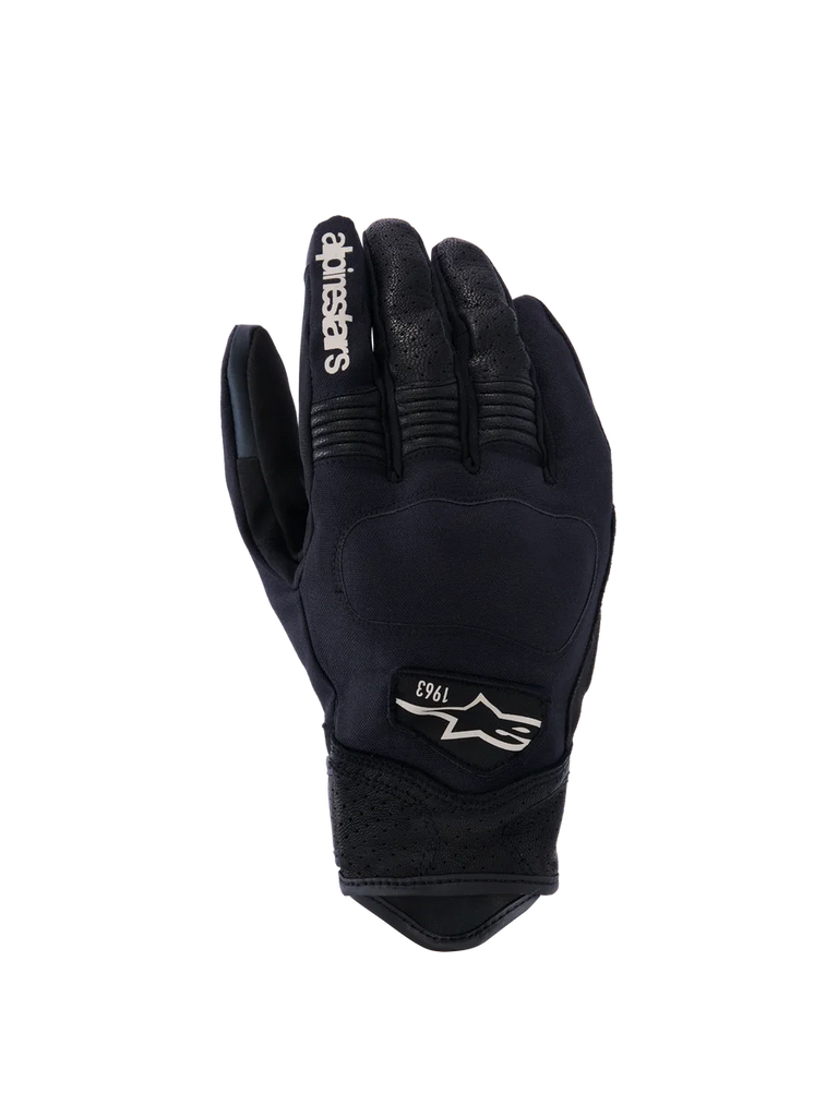 Alpinestars Tracker Gloves, Motorcycle Gloves, Black, backhand view showing stretch textile construction, perforated leather details on fingers and wrist, white branding on index finger, Alpinestars logo with 1963 on the back, padded knuckle area, short cuff urban design