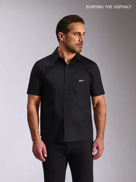 Alpinestars Strive Woven Shirt, short-sleeve button-front casual shirt worn by a male model, black stretch poplin, featuring a chest pocket with a white Alpinestars logo