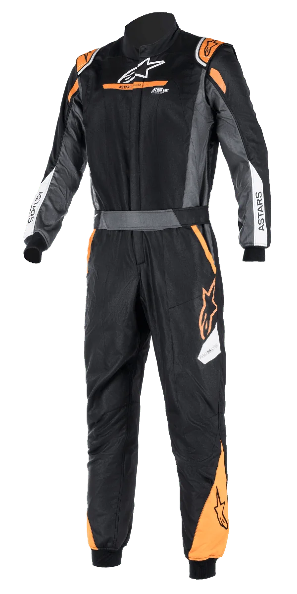 Alpinestars Atom FIA Graphic Suit, Black and Anthracite with Orange Fluo accents, one-piece FIA-certified auto racing suit, high collar, ASTARS branding on sleeves, professional motorsport and track competition gear