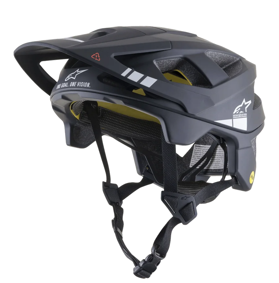 Alpinestars Vector Tech A1 MTB Helmet, Mountain Bike Helmet, Black and Light Gray Matt, white graphics and "ONE GOAL. ONE VISION." text, visible yellow MIPS inner lining, multiple ventilation openings, adjustable black straps with quick-release buckle, extended rear and side coverage, matte finish