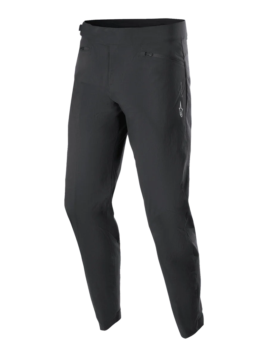 Alpinestars Youth A-Dura Pants, MTB Cycling Pants, Black, featuring two zippered front pockets and a small white Alpinestars logo on the left thigh, tapered leg design, durable stretch textile for youth mountain biking