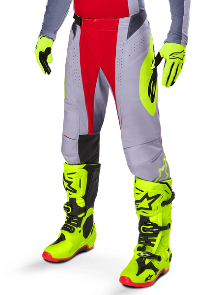 Alpinestars 2025 Techstar Melt Pants, Motocross Pants, Bright Red and Gray, featuring neon yellow side graphics and black knee panels, paired with matching neon yellow boots and gloves, designed for competitive off-road performance