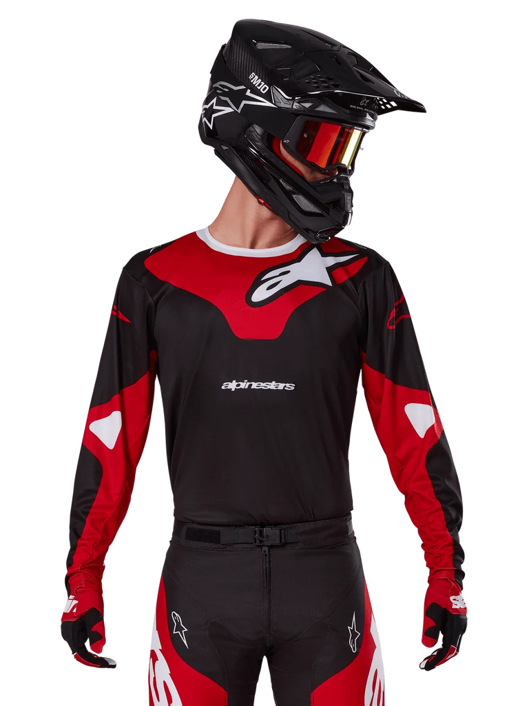 Alpinestars 2025 Racer Veil Jersey, Motocross Jersey, Black and Bright Red, worn with matching pants, black helmet, and red goggles, featuring bold white logos and a sleek racing design, performance gear for off-road motocross