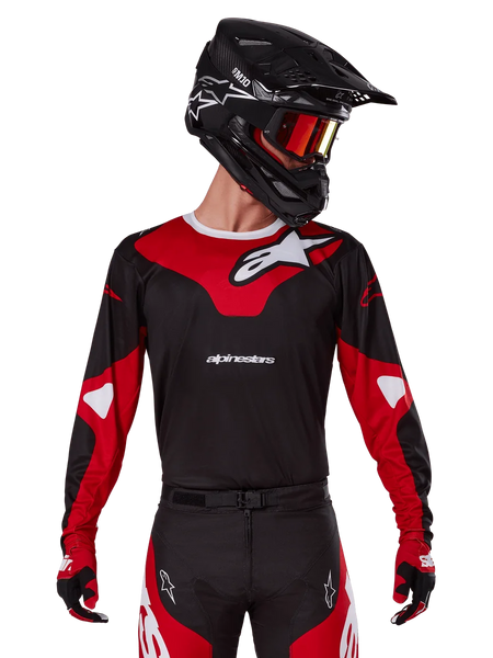 Alpinestars 2025 Racer Veil Jersey, Motocross Jersey, Black and Bright Red, worn with matching pants, black helmet, and red goggles, featuring bold white logos and a sleek racing design, performance gear for off-road motocross
