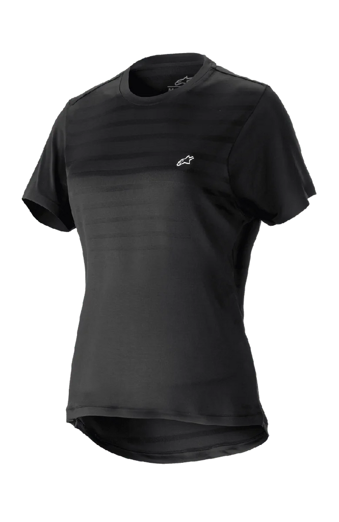 Alpinestars Women Stella Alps Constellation Jersey, Short Sleeve Mountain Bike Jersey, Black with subtle horizontal stripes on chest, small white logo, round neckline, extended tail for coverage, lightweight breathable fabric for MTB