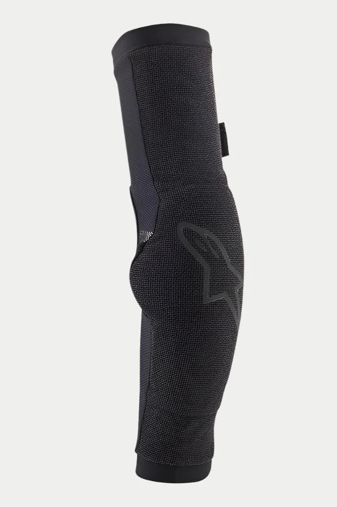 Alpinestars Paragon Pro Elbow Protectors, Black, slip-on elbow guards for mountain biking, featuring breathable mesh construction, ergonomic pre-shaped design, and a subtle Alpinestars logo on the side.