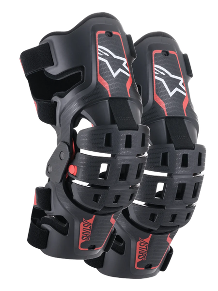 Alpinestars Youth Bionic 5S Knee Braces, Motocross Knee Protection, Black and Red, pair of protectors featuring a hybrid frame design with ventilated shells, white Astar logo on the upper section, red ASTARS branding on the lower section, and adjustable black straps for a secure fit.