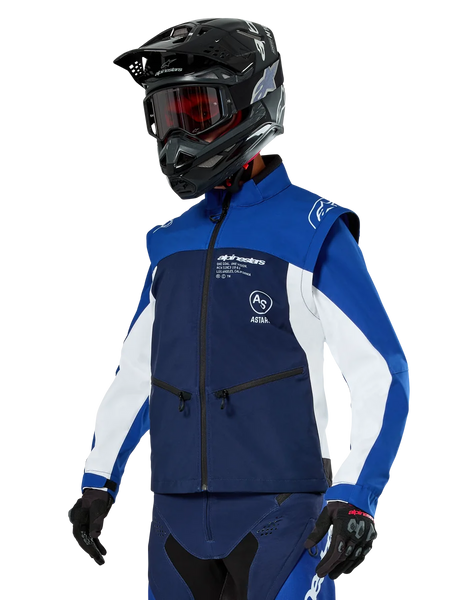 Alpinestars Lite-Dura Softshell Jacket, Navy, Bright Blue and White, Off-Road Enduro Jacket, worn with black helmet and red-tinted goggles, sporty color-block design with multiple zippers and brand logos, durable textile for motocross and trail riding
