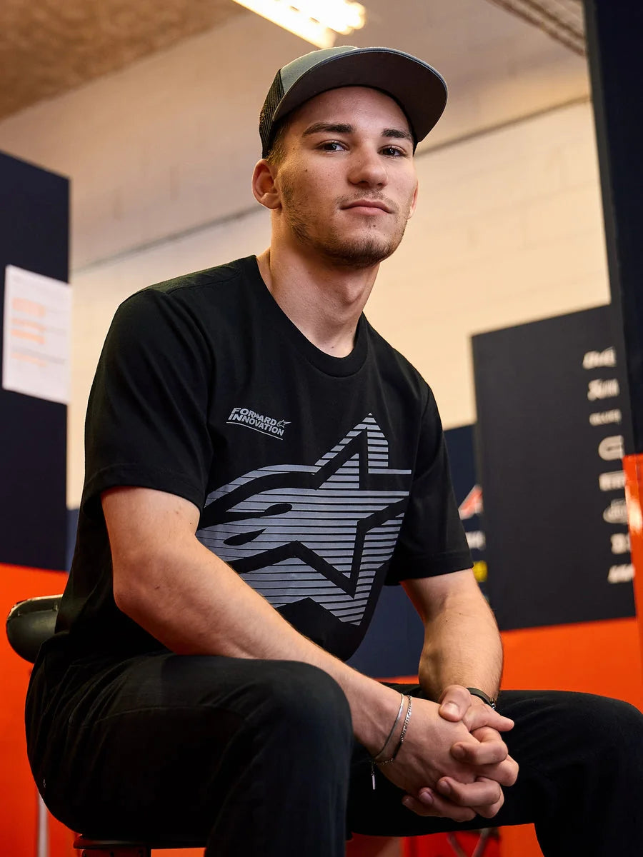 Alpinestars Fasting CSF Tee, Short Sleeve T-Shirt, Black, Large Gray Geometric Star Logo with Forward Innovation text, worn by a man in a casual motorsport setting, Lifestyle Sportswear