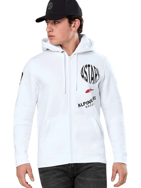 Alpinestars Variegate Hoodie, White Zip-Up Hoodie with black and red ASTARS racing graphics, worn by a model with a black cap and dark jeans, casual motorsport streetwear featuring a kangaroo pocket and drawstring hood