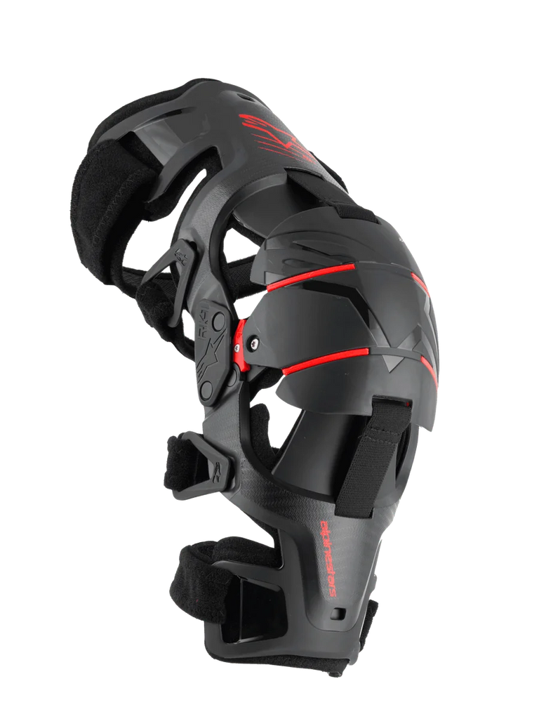 Alpinestars RK-1 Plasma Knee Brace, Motorcycle Knee Protection, Black and Red, side profile view featuring the articulated four-point hinge system, triple segmented knee cup, and adjustable straps for off-road racing