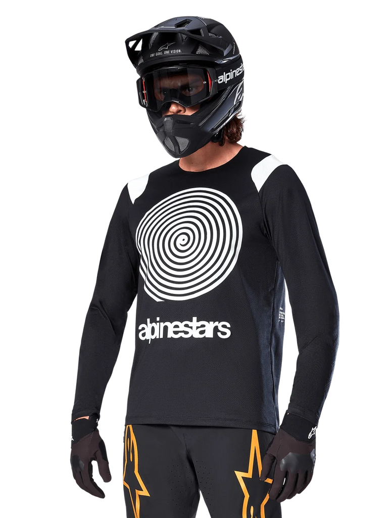 Alpinestars A-Supra Oscar Long Sleeve Jersey, MTB Cycling Jersey, Black and White, featuring a bold white spiral design and Alpinestars logo on the chest, worn with a black full-face helmet and goggles, performance mountain biking apparel