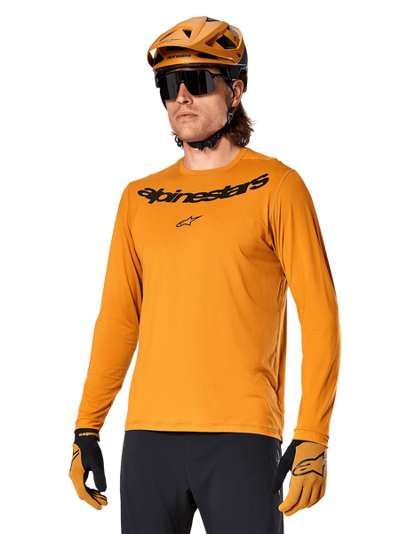 Alpinestars A-Dura Rocker Long Sleeve Jersey, MTB Mountain Biking Jersey, Dark Gold, person wearing jersey with matching helmet and gloves, sporty coordinated look with Alpinestars wordmark on chest