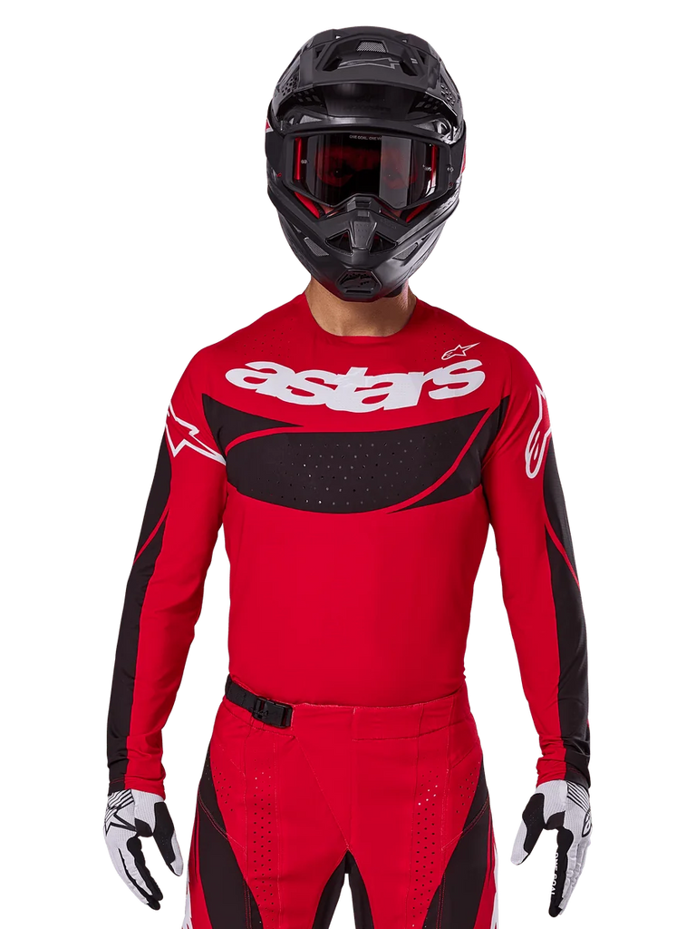 Alpinestars 2025 Techstar Dreem Jersey, Motocross Gear, Bright Red and Black, featuring a white 'astars' logo and black ventilated chest panel, worn with matching pants, black helmet, and white and black gloves, designed for professional off-road racing