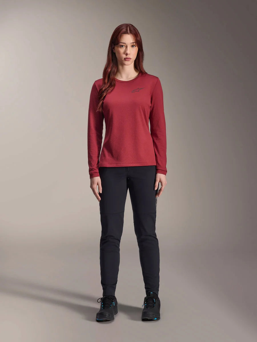 Alpinestars Stella A-Dura Thermal Pant, Women's MTB Pants, Black, worn with a maroon long-sleeve technical jersey, slim-fit thermal design for cold weather cycling, durable outer shell with brushed fleece lining