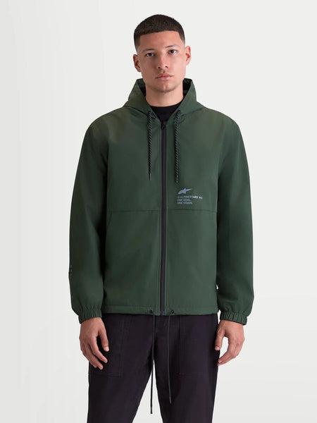 Alpinestars Speeder Resolve Windbreaker Jacket, Lightweight Hooded Sportswear on Model, Pine Green, Featuring Reverse-Coil Zipper, Adjustable Hood, and Signature Chest Branding with One Goal One Vision Motto