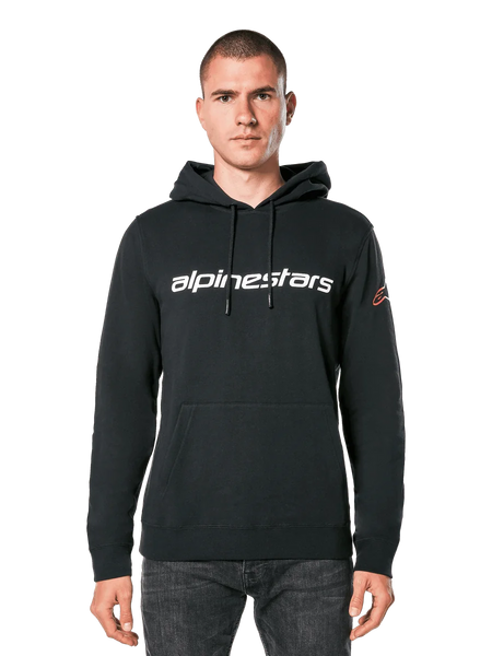 Alpinestars Linear Wordmark V3 Hoodie, Black Pullover Hoodie, White Alpinestars wordmark on chest, Red Ageless sleeve logo, front kangaroo pocket, drawstring hood, worn by a male model, casual motorsport-inspired streetwear