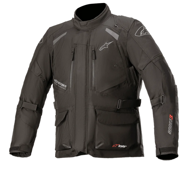 Alpinestars Andes V3 Drystar Jacket, Motorcycle Adventure Touring Jacket, Black with white and red branding, features multiple waterproof cargo pockets, adjustable straps for a custom fit, weather-resistant textile construction, reflective panels for visibility