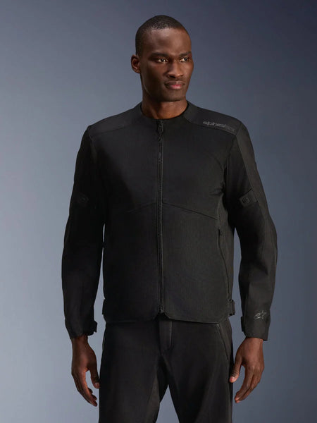 Male model wearing Alpinestars C-1 Air Jacket in Black, contemporary motorcycle jacket with extensive tech mesh panels and a full front zipper, paired with matching black riding pants, urban lifestyle and commuting aesthetic