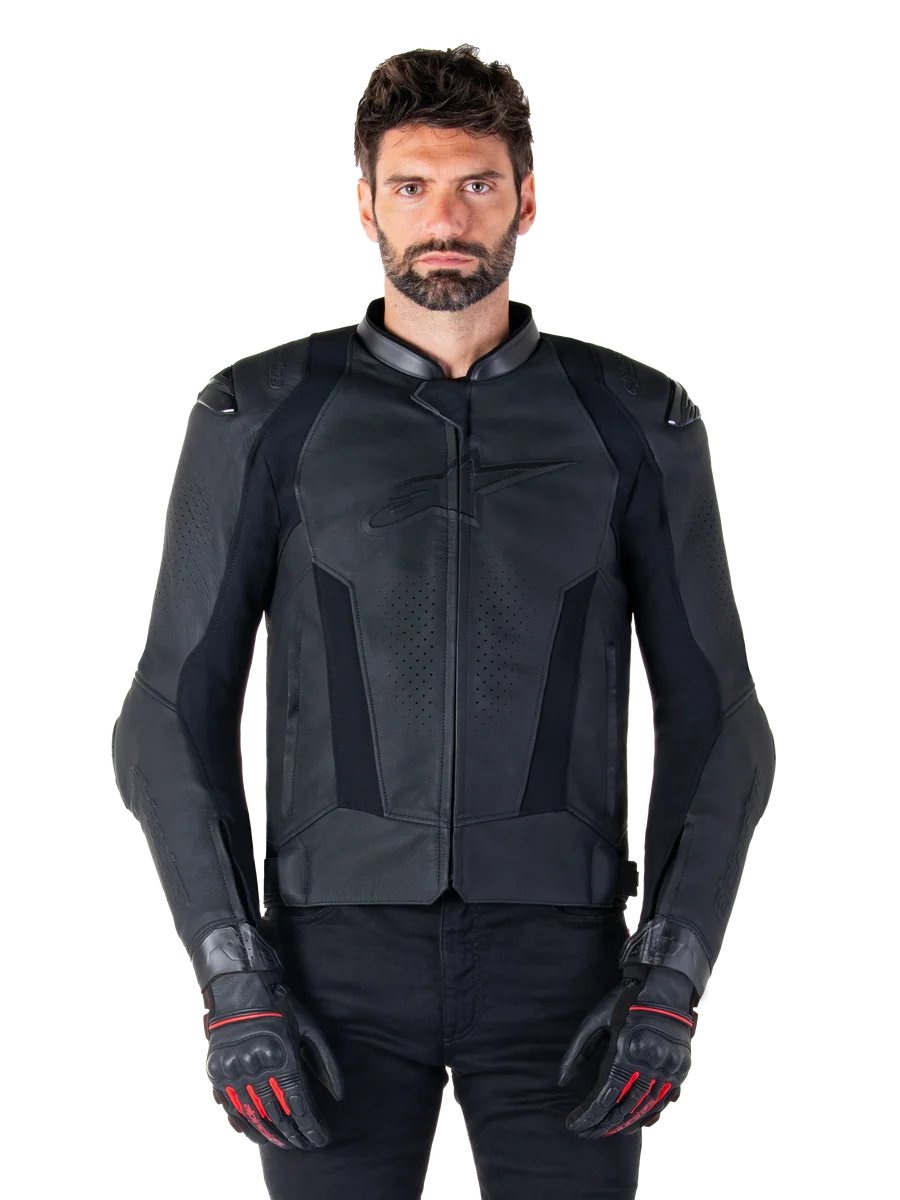 Alpinestars Missile V3 Leather Jacket, Black Motorcycle Racing Jacket, worn by model with matching black gloves and pants, featuring perforated leather for ventilation, external shoulder sliders, and sleek sport riding design