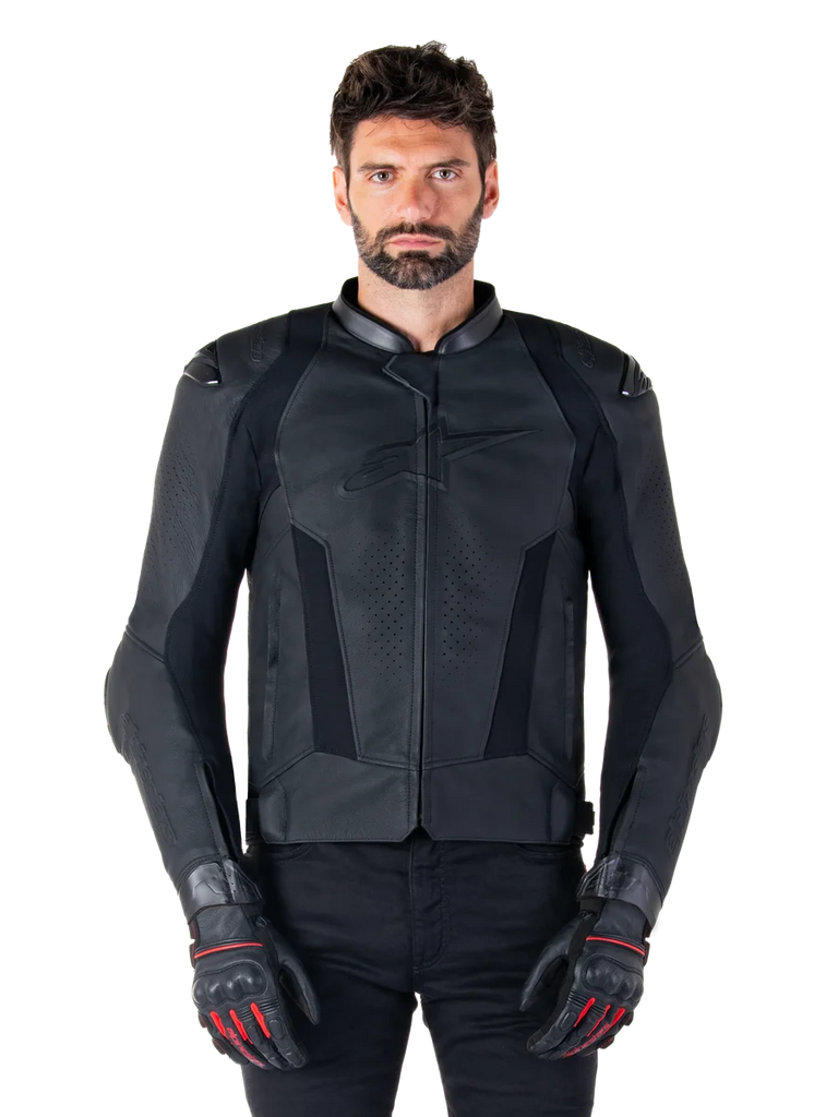 Alpinestars Missile V3 Leather Jacket, Black Motorcycle Racing Jacket, worn by model with matching black gloves and pants, featuring perforated leather for ventilation, external shoulder sliders, and sleek sport riding design