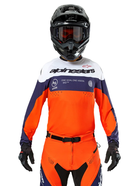 Alpinestars Pro-Dura Jersey, Motocross Jersey, Navy Blue, Hot Orange, and White, worn with a black helmet and gloves, featuring laser-perforated ventilation zones, bold branding, and "ONE GOAL. ONE VISION." chest graphic