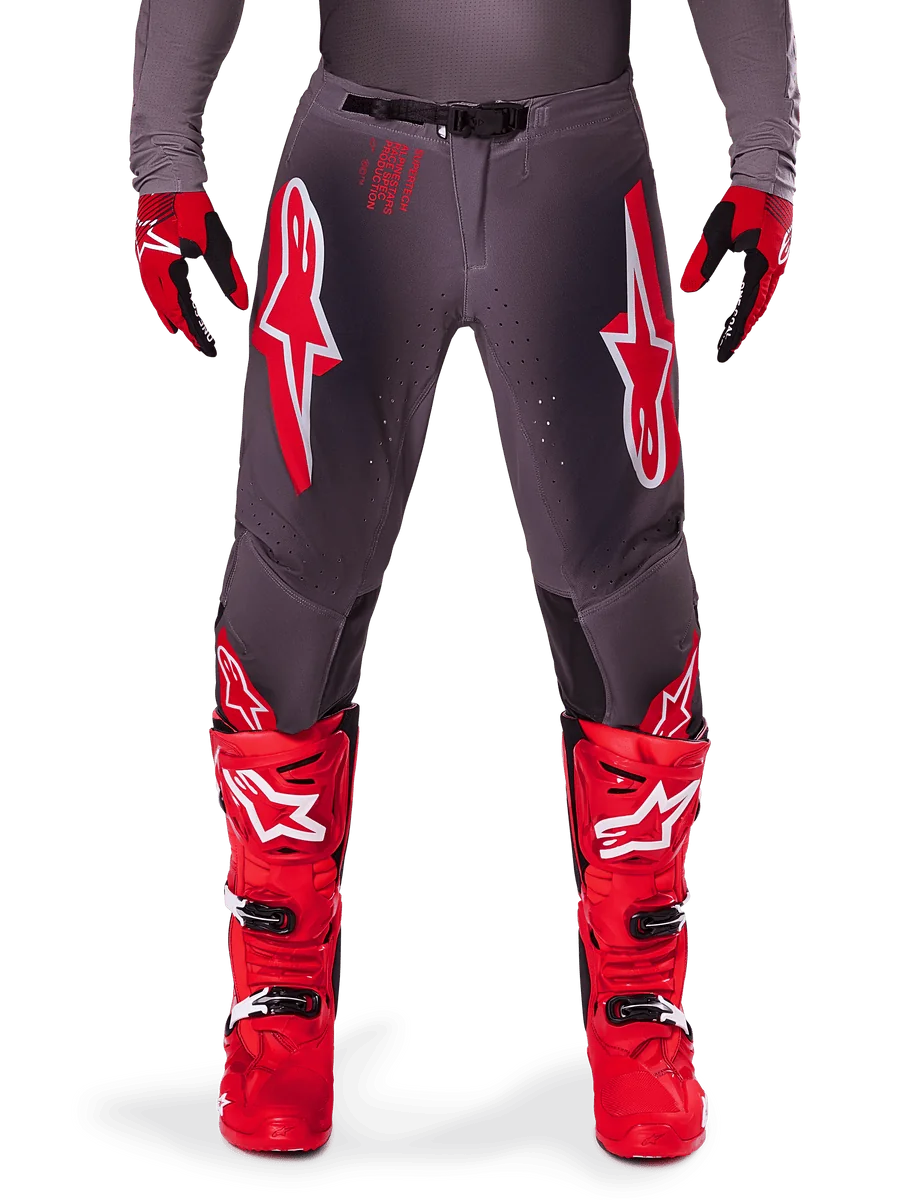 Alpinestars 2025 Supertech Lipan Pants, Motocross Pants, Smoke Bright Red, gray chassis with prominent red and white logos, styled with red racing boots and gloves, featuring perforated ventilation, high-performance off-road gear