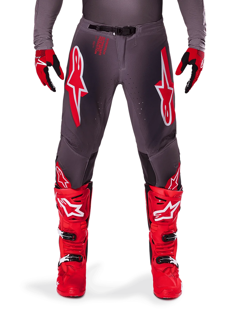 Alpinestars 2025 Supertech Lipan Pants, Motocross Pants, Smoke Bright Red, gray chassis with prominent red and white logos, styled with red racing boots and gloves, featuring perforated ventilation, high-performance off-road gear