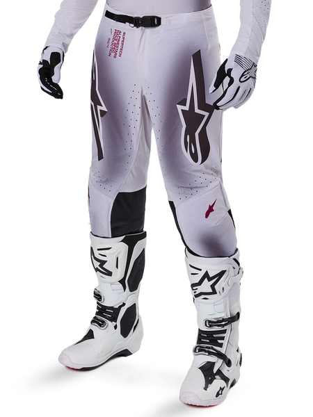 Alpinestars 2025 Supertech Maker Pants, Motocross Racing Pants, Silver and Black, featuring large star logos and red lettering, shown with matching white boots and gloves