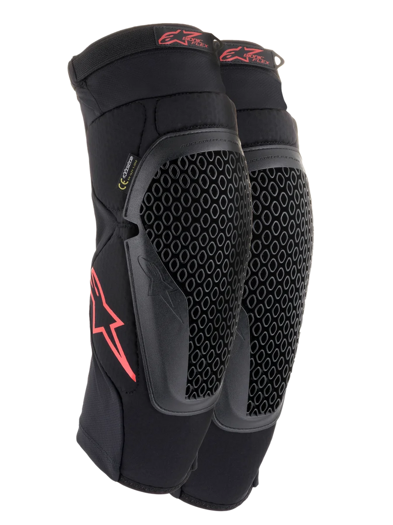 Alpinestars Bionic Flex Knee Protectors, Black and Red, pair of motocross knee guards featuring perforated Nucleon Flex Technology shields, red Astars logos, and elasticated straps on a breathable black mesh sleeve.