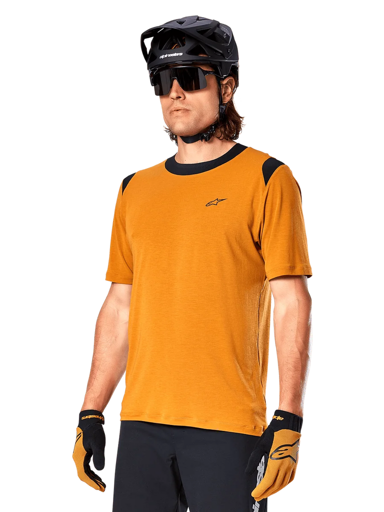 Alpinestars A-Dura Dri Wool Jersey - Short Sleeve, MTB cycling jersey, Dark Gold with black accents, short-sleeve technical wool blend shirt with black shoulder panels, worn with black mountain bike helmet and matching gloves