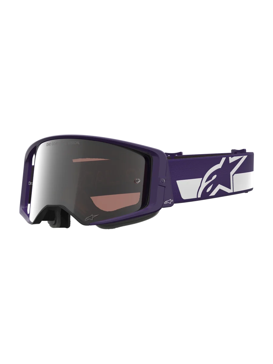 Alpinestars Limited Edition HUNTA96 XXV Supertech Vision Goggles, Motocross Goggles, Purple and White with Silver Mirror Lens, featuring "ONE GOAL. ONE VISION." text on the lens, wide adjustable strap with prominent Alpinestars logo, high-performance protective eyewear for off-road racing