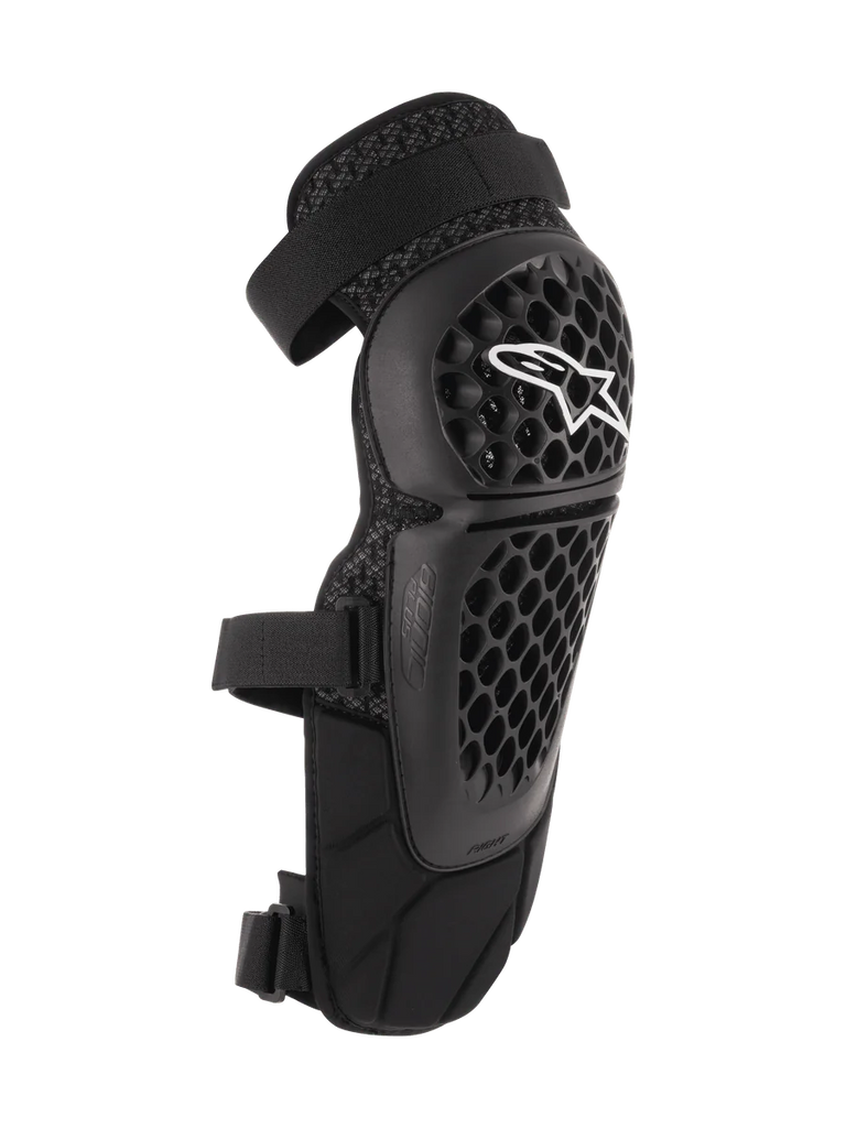 Alpinestars Bionic Plus Knee/Shin Protectors, Black, Off-road and MTB Protection, featuring a perforated honeycomb shell with a white Alpinestars logo, dual adjustable straps, and 3D mesh ventilation, ergonomic curved design