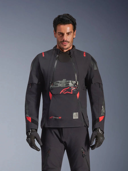 Alpinestars Halo Pro Drystar® XF Laminated Jacket, Adventure Motorcycle Jacket, Black Dark Shadow with red accents, male model wearing full technical gear including matching gloves and pants, front view highlighting modular chest ventilation panels and waterproof construction.