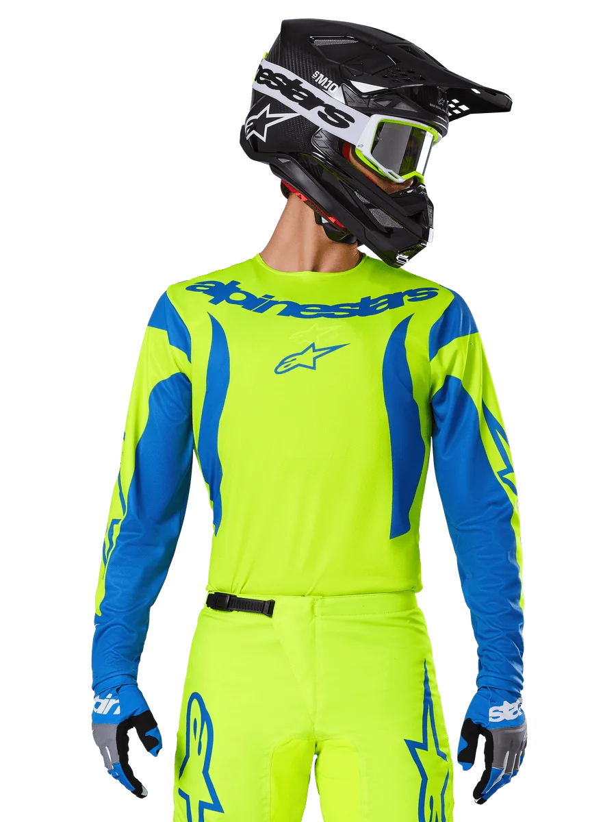 Alpinestars 2025 Fluid Haul Jersey, Motocross Jersey, Neon Yellow and Blue, featuring blue Alpinestars branding on the chest, worn with matching gear including a black helmet and blue gloves, athletic fit for off-road riding