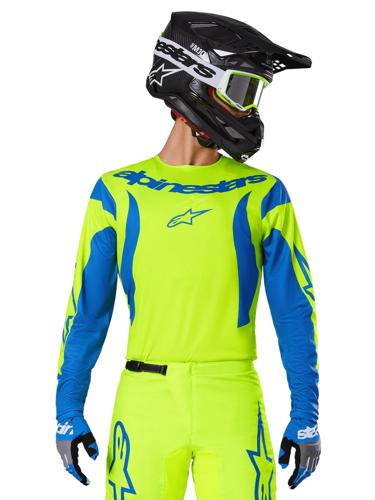 Alpinestars 2025 Fluid Haul Jersey, Motocross Jersey, Neon Yellow and Blue, featuring blue Alpinestars branding on the chest, worn with matching gear including a black helmet and blue gloves, athletic fit for off-road riding