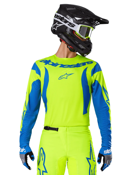 Alpinestars 2025 Fluid Haul Jersey, Motocross Jersey, Neon Yellow and Blue, featuring blue Alpinestars branding on the chest, worn with matching gear including a black helmet and blue gloves, athletic fit for off-road riding