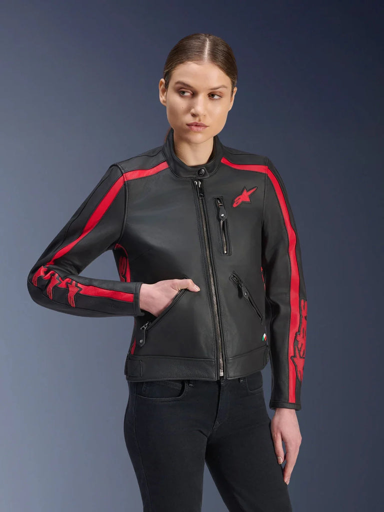 Alpinestars Stella Dyno Leather Jacket, Women's Motorcycle Jacket, Black Haute Red, worn by a model with black jeans, featuring red racing stripes on shoulders and sleeves with bold branding, premium leather construction, heritage-inspired design for urban riding