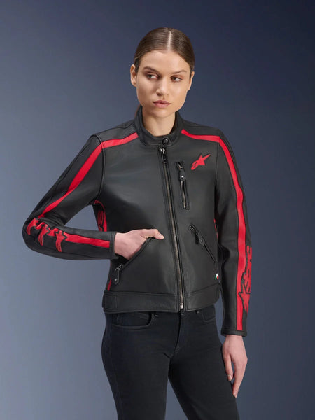 Alpinestars Stella Dyno Leather Jacket, Women's Motorcycle Jacket, Black Haute Red, worn by a model with black jeans, featuring red racing stripes on shoulders and sleeves with bold branding, premium leather construction, heritage-inspired design for urban riding